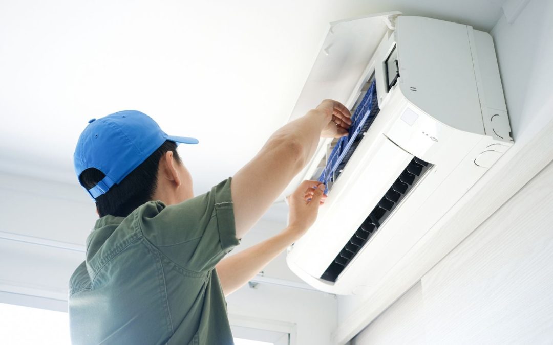 Air conditioning technician maintaining an indoor mini split system in San Tan Valley, AZ
