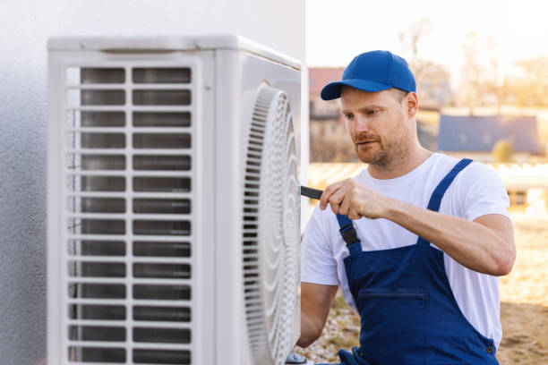 HVAC technician servicing an outdoor air conditioning unit in San Tan Valley