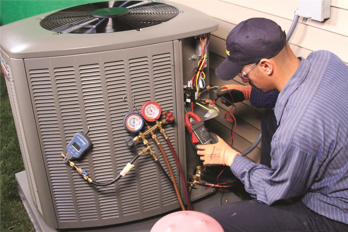 HVAC technician testing an outdoor air conditioning unit in San Tan Valley