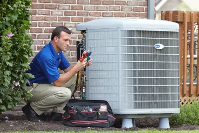 design-air-heating-and-air-conditioning-decatur-il-05 – Copy HVAC technician inspecting an outdoor air conditioning unit in San Tan Valley, AZ